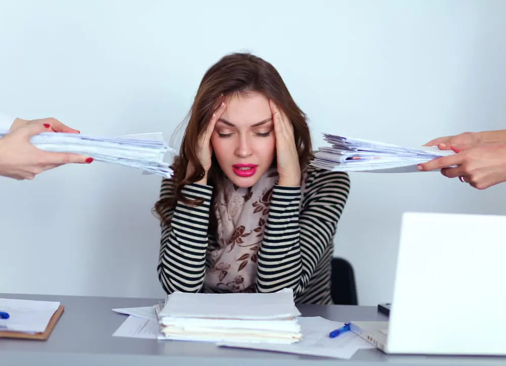 young business woman overwhelmed at work