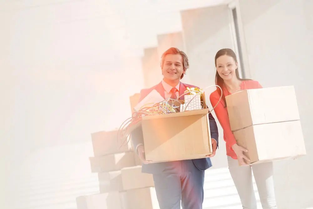 Office staff moving boxes for relocation