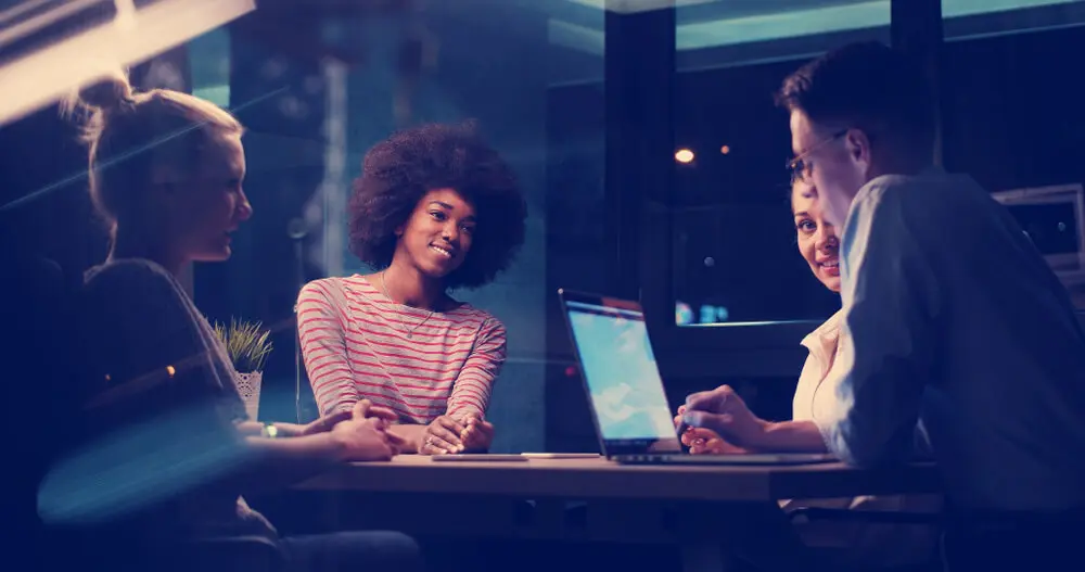 Business professionals meeting around computer