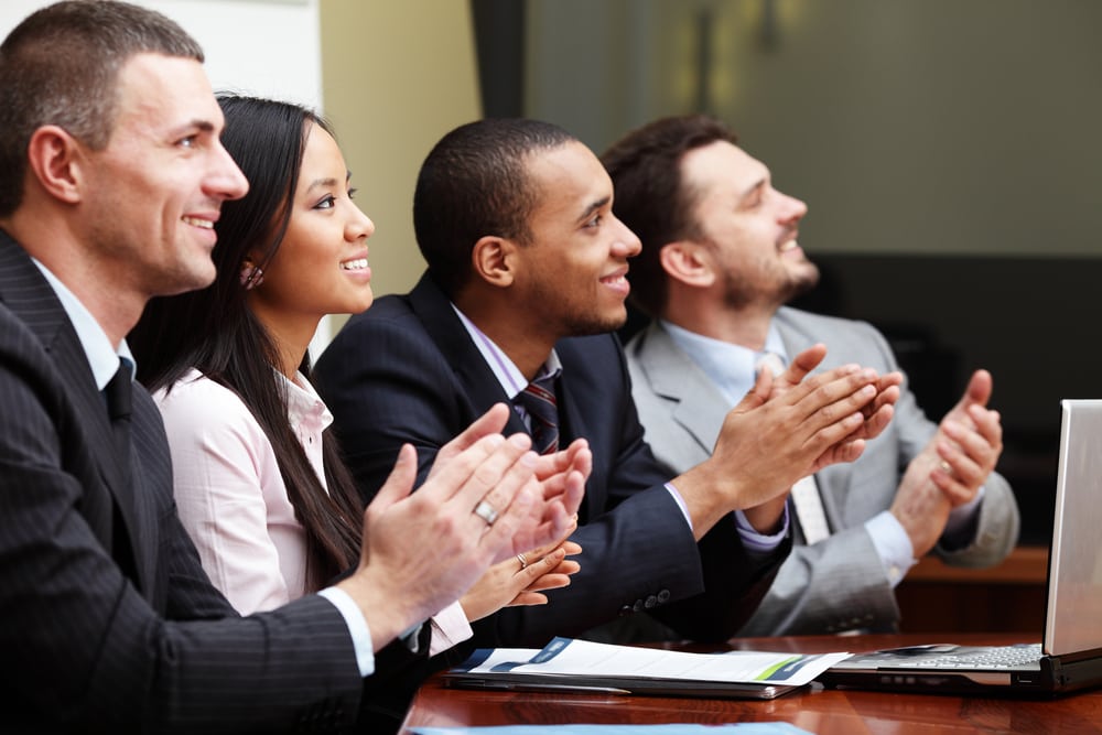 Business professionals applauding a presentation