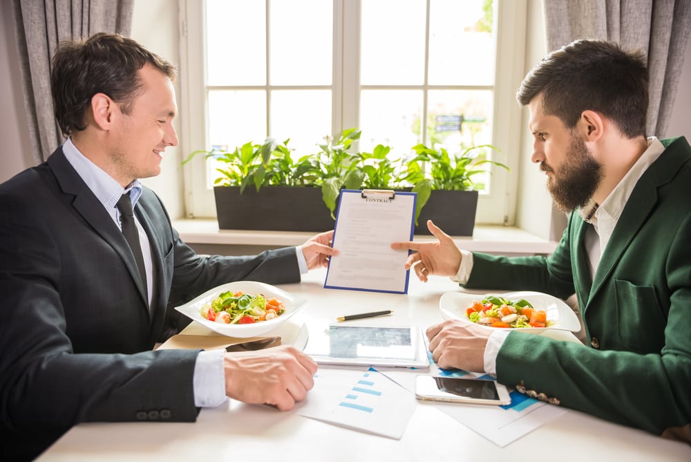 Two men having a discussion during a business lunch