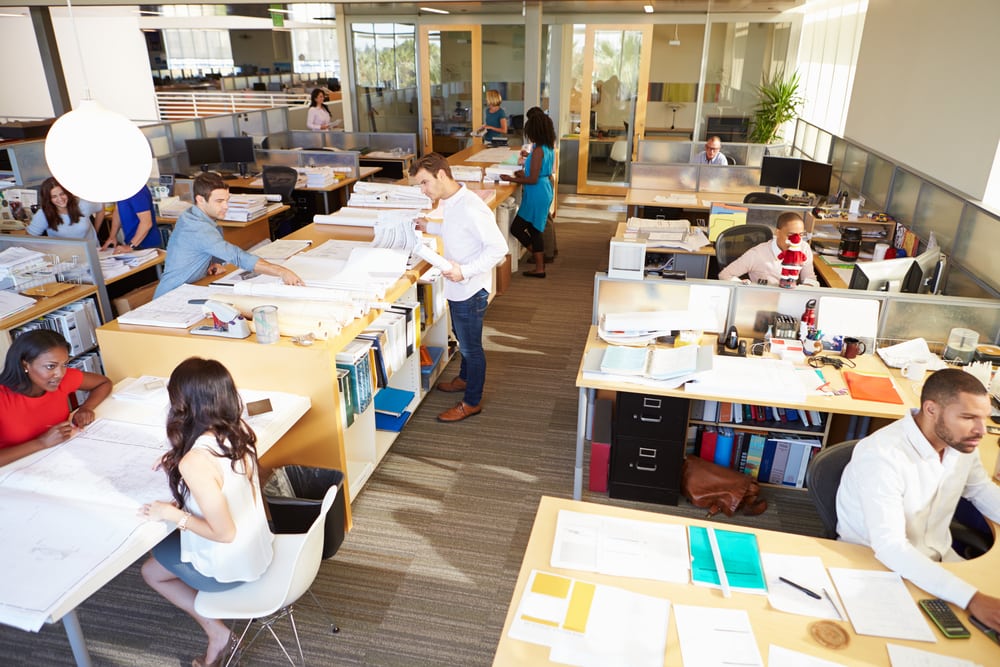 Employees working collaboratively in an open floor plan office