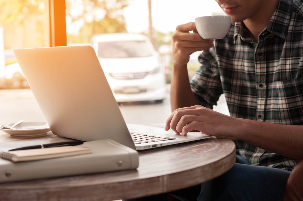 Frustrated freelancer working in coffee shop