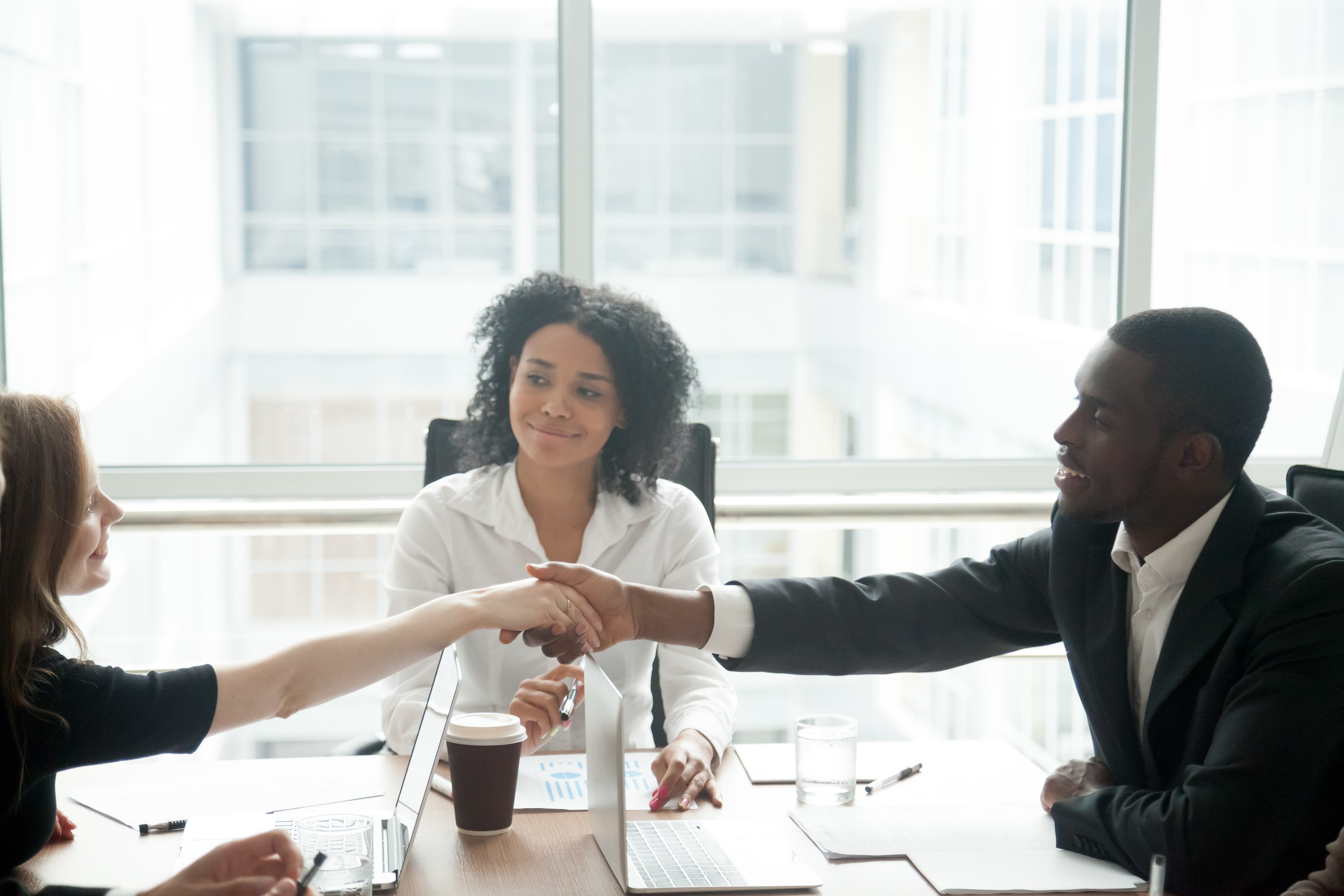 Manager using conflict resolution skills to help employees come to an agreement