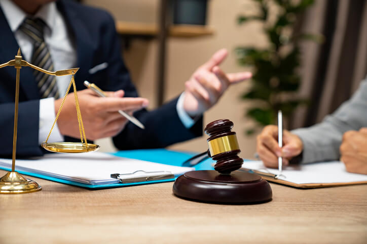 Lawyer speaking to client in their office in a class A building in NYC